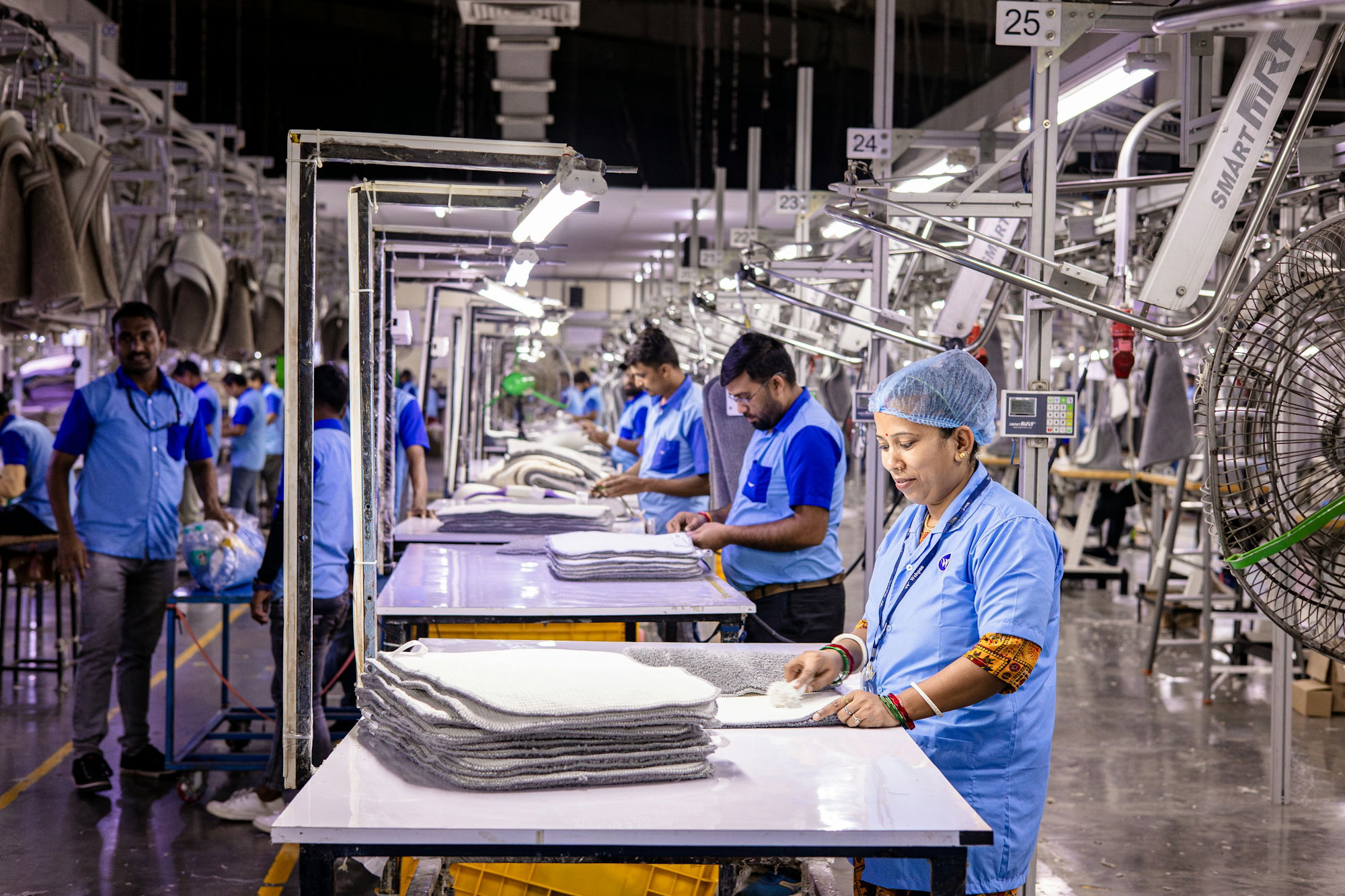 workers-are-busy-in-an-industrial-garment-factory-.jpg Workers are busy in an industrial garment factory.